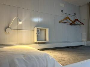 a bedroom with a bed and a small mirror at Hostel Cantinho do Mar in Salvador