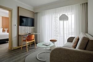 a living room with a couch and a table at Malta Marriott Resort & Spa in St. Julianʼs