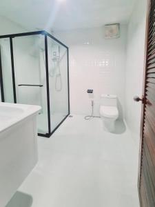 a white bathroom with a shower and a toilet at Star house Seaview Lanta old town in Ko Por +13 photos