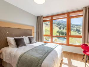 a bedroom with a bed and a large window at Duplex 4 chambres avec piscine, spa et parking aux Arcs 1800 - FR-1-352-55 in Arc 1800 +19 photos