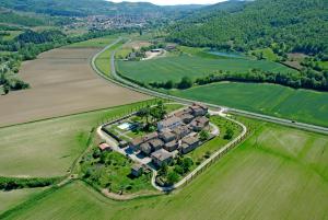 a large house in the middle of a field at Appartamento in Fattoria in Capolona +5 photos