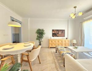 a living room with a table and a dining room at Our home Our heaven in Madinaty