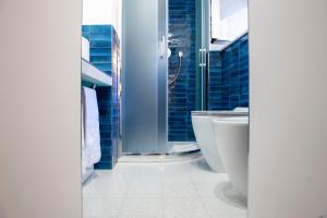 a bathroom with a toilet and a glass shower at Costaguti Holiday Apartment in Rome