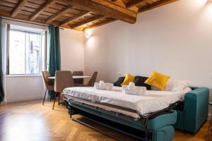 a large bed in a room with a table and chairs at Costaguti Holiday Apartment in Rome