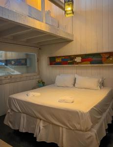 a bedroom with a large bed in a room at As Palhas in Amontada