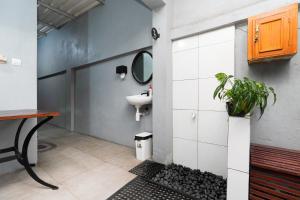 a bathroom with a sink and a mirror at Indraloka Heritage Homestay in Yogyakarta +31 photos