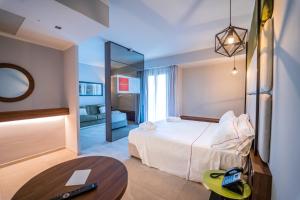 a hotel room with a bed and a table at Best Western Plus Sabaudia Hotel in Sabaudia