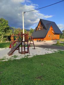 a playground in front of a house at Wood Fairy 2 in Korenica