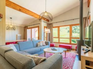 a living room with a couch and a tv at Duplex 4 chambres avec piscine, spa et parking aux Arcs 1800 - FR-1-352-55 in Arc 1800