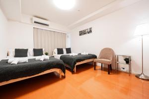 Lova arba lovos apgyvendinimo įstaigoje Shinjuku luxury Apart ment 2 minutes from Higashi-Shinjuku