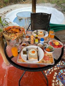 a table with a plate of breakfast food on it at Chiang Dao Roundhouses in Chiang Dao