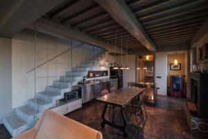 a living room with a table and a staircase at Podere San Pasquale in Castiglione dʼOrcia