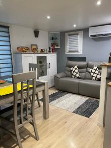 a living room with a couch and a table at La maison de Tedone in Arles-sur-Tech