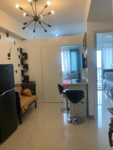 a living room with a couch and a ceiling fan at Smdc south Residences almanza uno in Manila