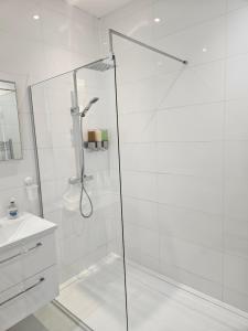 a shower with a glass door in a bathroom at Langhouse Castle Bed and Breakfast in Inverkip