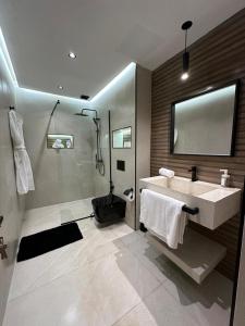 a bathroom with a sink and a shower at Centrico 8 Tanger Bendiban in Tangier