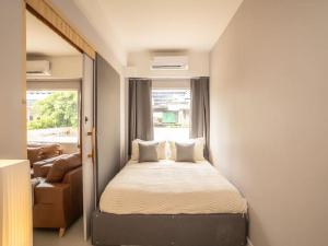 a small bedroom with a bed and a couch at 2-Bedroom apartment for 4 guests, Center-Silom - 3A in Bang Rak