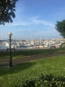 a park with a view of a harbor with boats at Oscar's At the Marina in Bangor
