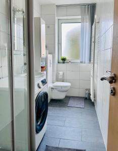 a bathroom with a toilet and a sink and a shower at Nobel die Gemütliche Fewo mit besten Lage in Doos