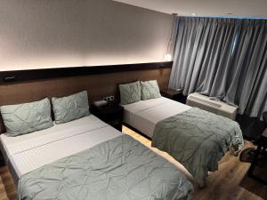 Postel nebo postele na pokoji v ubytování Hotel Mirage Brooklyn
