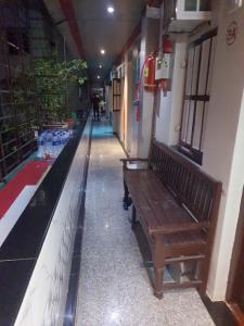a hallway with a bench next to a swimming pool at Ram niwas hotel in Mumbai