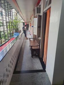 a hallway of a building with a bench and windows at Ram niwas hotel in Mumbai