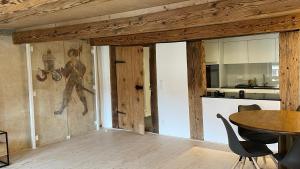 a kitchen and dining room with a wooden ceiling at a knight's splendid apartment in Büren an der Aare