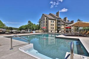 a large swimming pool in front of a building at Luxury Condo with Garage Parking and Pool in Killington