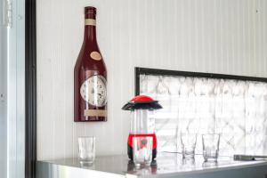 a bottle of wine sitting on a table next to glasses at Hacienda Posada de Amor in Maunabo +10 photos