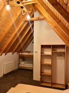 a room with two bunk beds in a attic at Alpin Chalet in Rucăr +12 photos