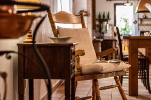 a wooden chair in a kitchen with a table at Copper House in Lanciano