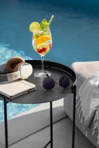 a table with a drink and sunglasses on a boat at Villa Bewegte Berge in Kaštelir