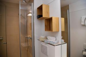 a bathroom with a shower and a glass shower stall at Strandhotel Seehof in Überlingen +41 photos