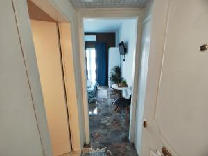 a hallway leading to a room with a table at Blue Dreams in Veria