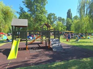 a playground in a park with people playing at Sunshine Vendégház Balatonfenyves in Balatonfenyves