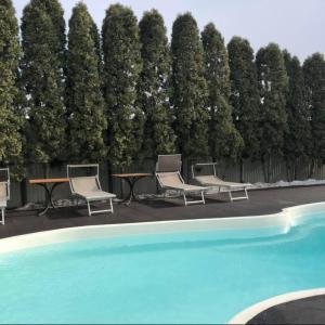 a group of chairs and a table next to a pool at Sport Hotel 2 in Cherkasy +23 photos