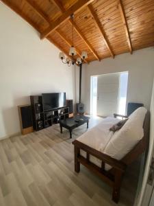 a bedroom with a bed and a living room at El descanso in Ramallo