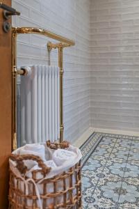 a bathroom with a radiator and a basket on the floor at 1 bed house in Hampshire in Chandlers Ford