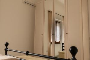 a bedroom with a mirror next to a bed at Casa Corona in Capoterra +12 photos