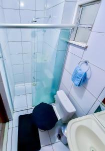 a bathroom with a shower and a toilet and a sink at Apê Bela Vista com Piscina I Wi-Fi e A/C in Imperatriz +24 photos