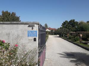 a fence with a sign on it next to a road at Studio Clos-Edeen in Tréclun