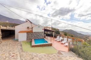 a house with a swimming pool on a balcony at Casa Rural de Perera in San Bartolomé de Tirajana