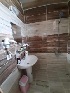 a bathroom with a sink and a shower at Parasut Village Hotel in Kargakonmaz
