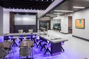 a conference room with purple chairs and tables at Courtyard by Marriott Houston Heights/I-10 in Houston
