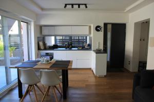 a kitchen with a table and chairs in a room at Apartment Abtei Sayn in Bendorf