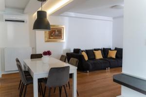 a living room with a white table and a couch at Fantabulous Old Town Condo in Zagreb