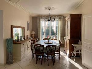 a dining room with a table and chairs at Maison lumineuse et élégante in Chartres