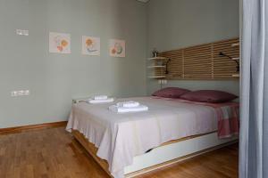 a bedroom with a bed with towels on it at Minimal Central Apartment By The Sea in Volos +18 photos