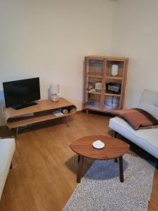 a living room with a couch and a table at Beachbungalow in Karlshagen