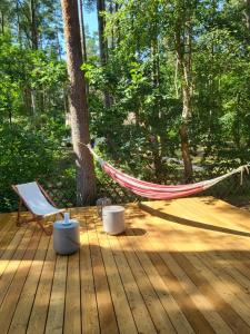 a hammock on a deck in the woods at Beachbungalow in Karlshagen